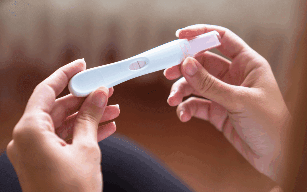 woman holding a positive pregnancy. test